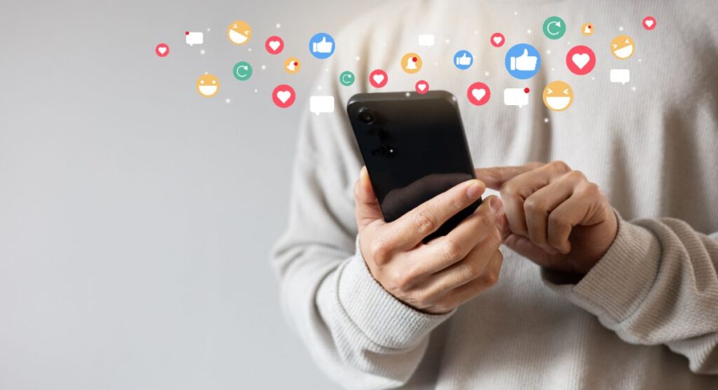Adult man holding a smartphone to use social media