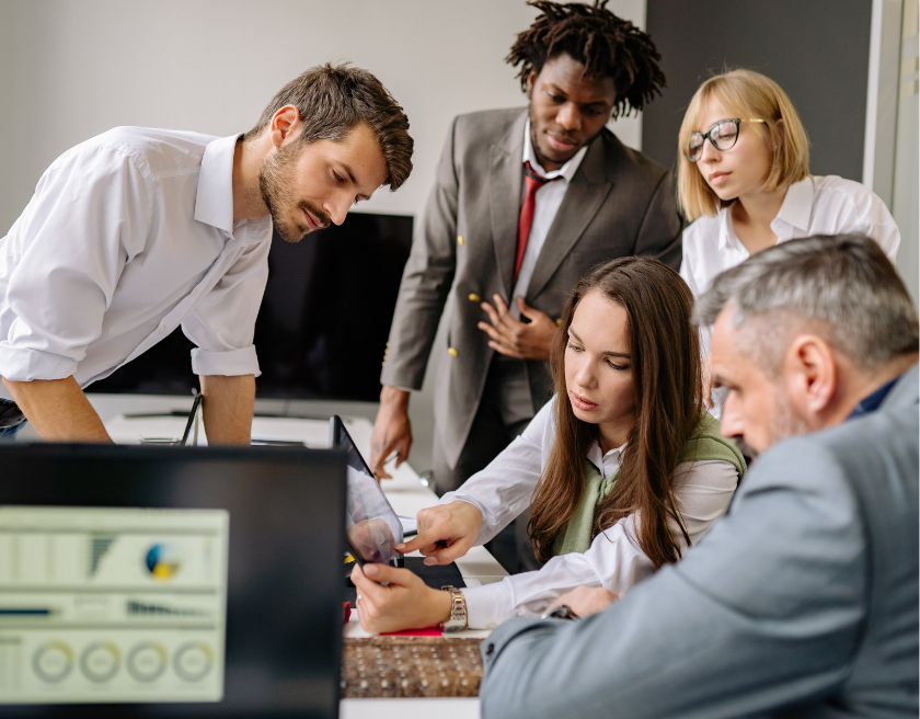 Evergreen Marketing team presenting digital analytics and campaign performance data during a strategic business meeting in a modern high-rise office.