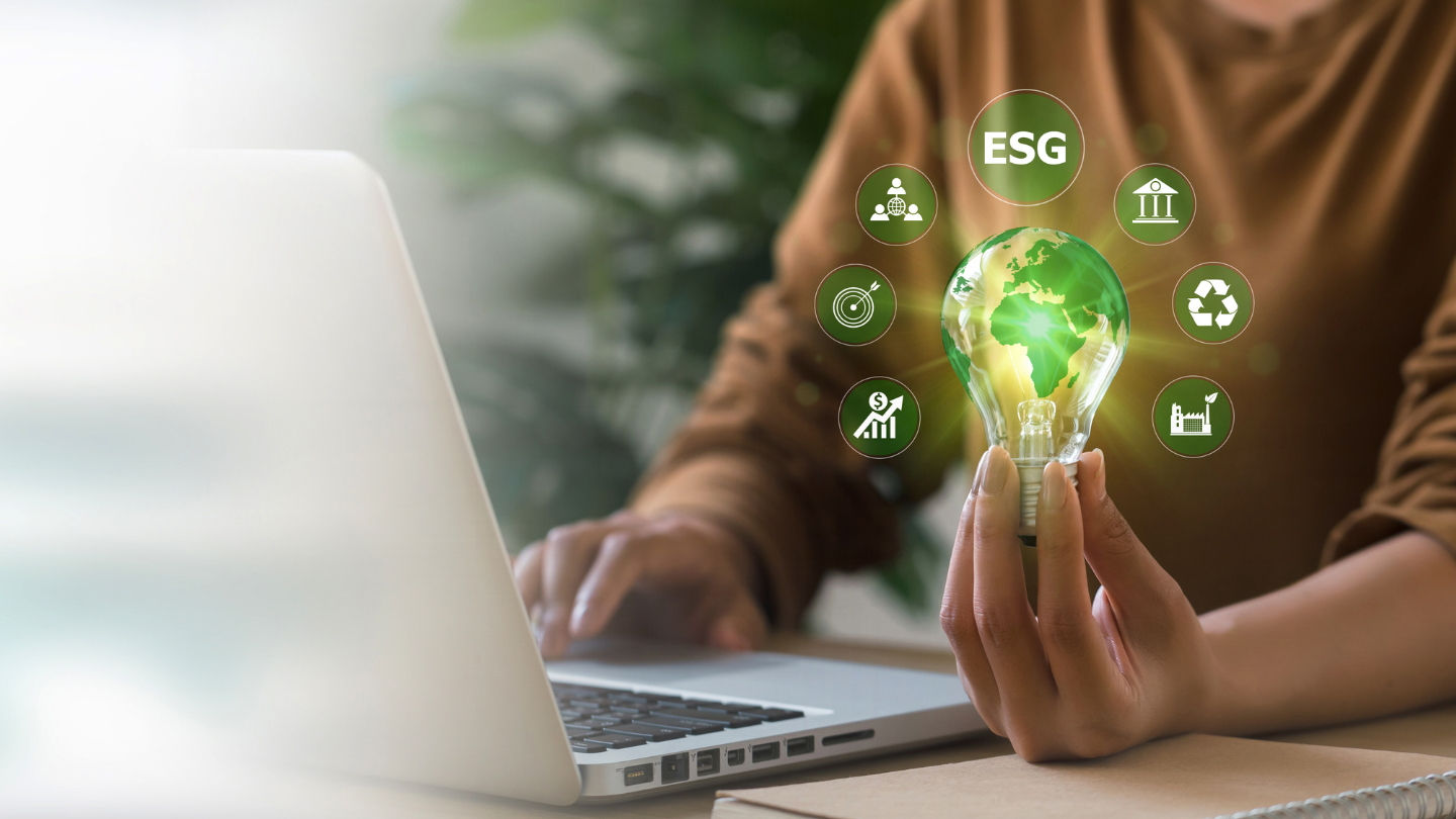 Concept of sustainable business strategy, showing a hand holding a lightbulb that symbolizes ESG initiatives, green innovation, and corporate responsibility.