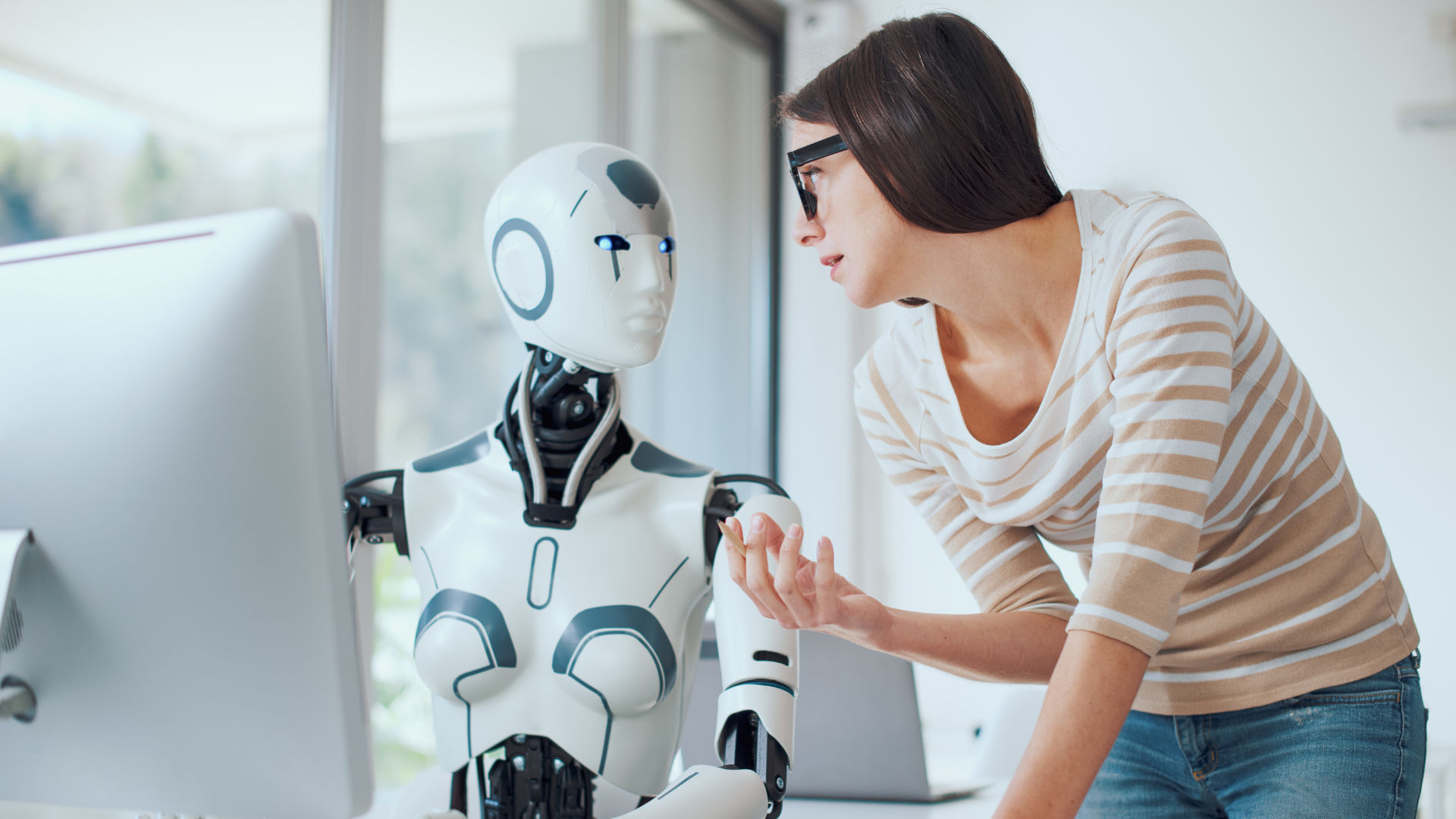 What Is AEO? The New Trend That's Even More Powerful Than SEO Human-AI collaborationA woman is consulting with a humanoid robot in an office setting