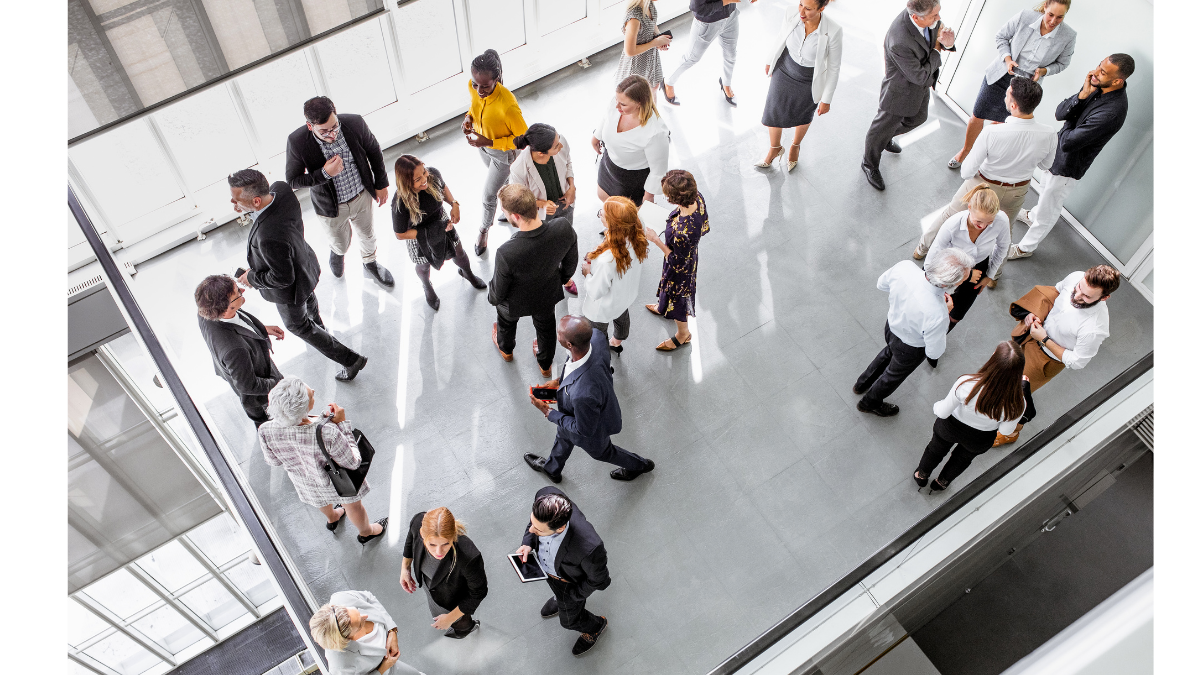 A high-angle view of a vibrant professional networking event, illustrating the offline activation phase of an O2O strategy where online community members from Xiaohongshu transition into a physical brand experience.