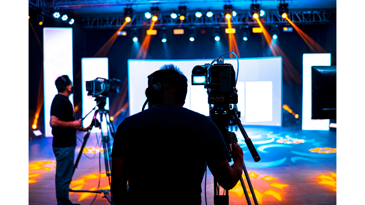 A flat lay of an office desk featuring a notebook with the word 'EVENTS' written on it, positioned next to a clock and keyboard to represent the strategic scheduling and planning of an O2O brand activation.
