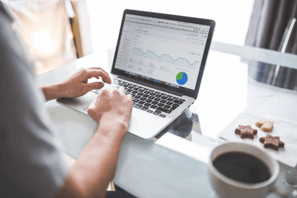 person-analyzing-website-analytics-on-a-laptop-with-charts-displayed