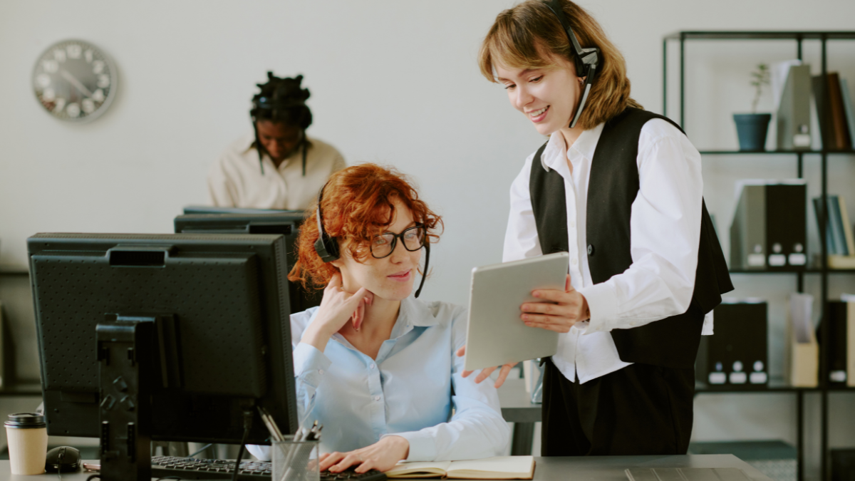 Team members reviewing content on a tablet in a workspace, representing organic content seeding and subtle brand communication without direct advertising.