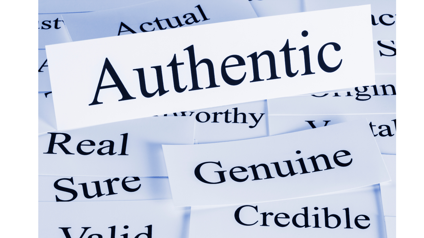 Close-up of paper slips featuring words like 'Authentic,' 'Genuine,' 'Real,' and 'Credible,' symbolizing the value of the 'Human Made' seal and the authenticity premium in modern marketing.