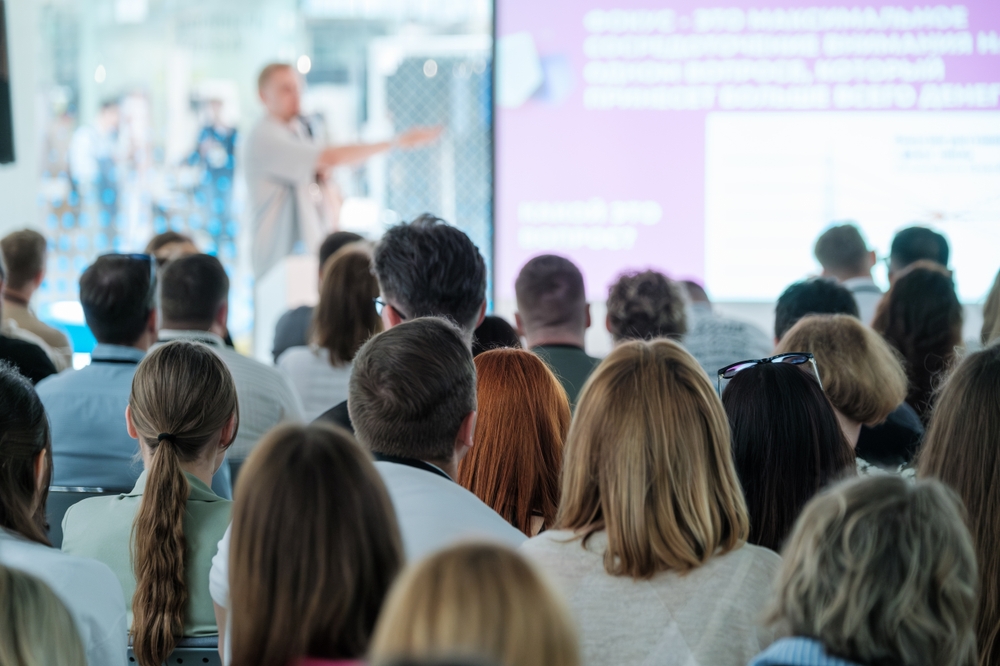 Large group of people attending a business conference