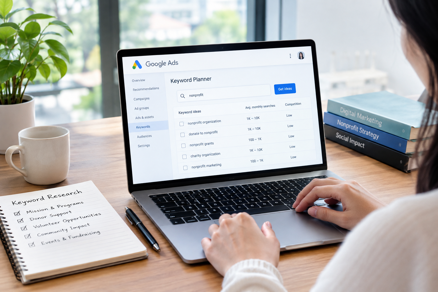 Woman analyzing digital marketing data on a laptop for Google Ad Grants Keyword Research.